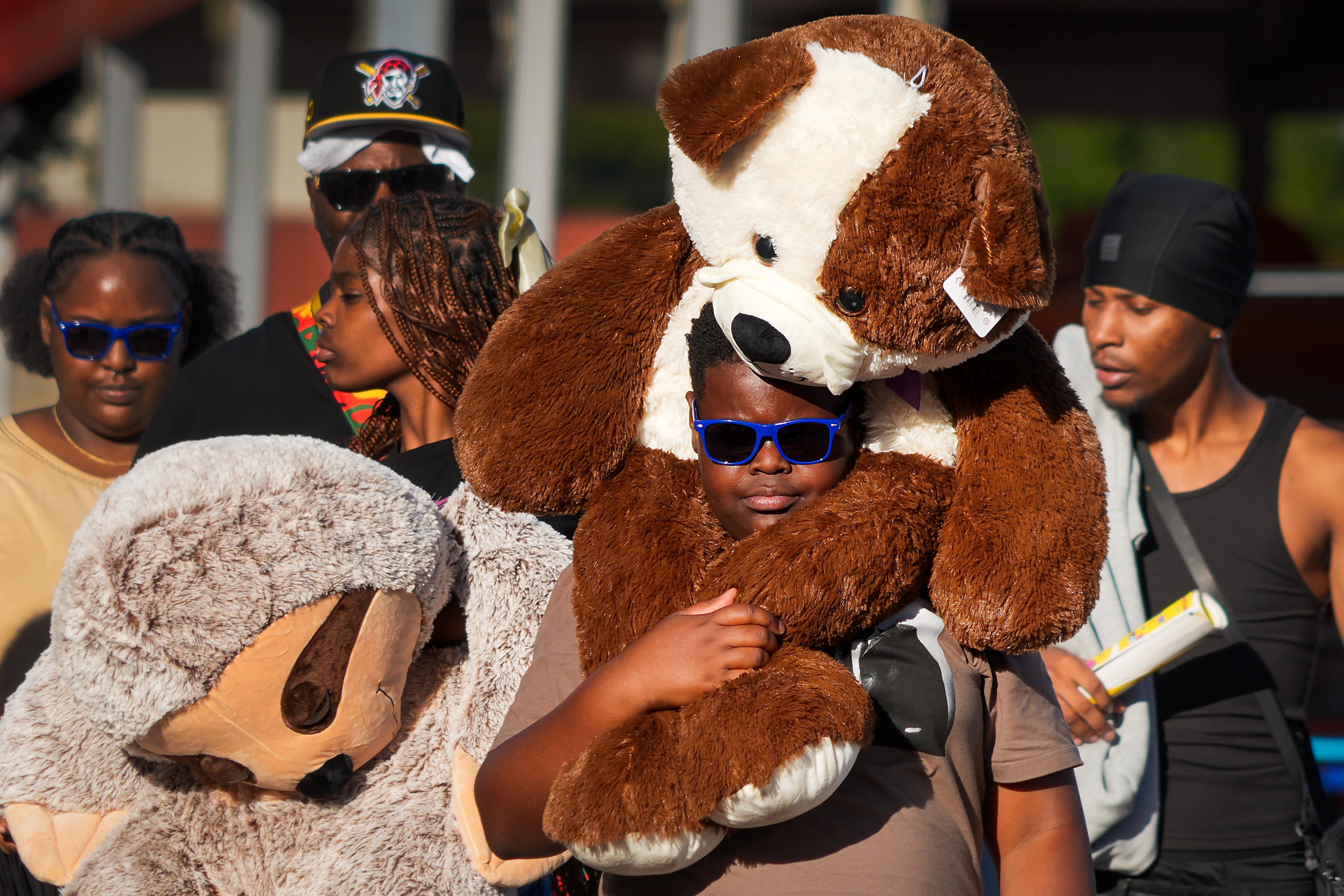 Kanon Lacy,12, carries a plush toy atop is his shoulders on the midway at the State Fair of...