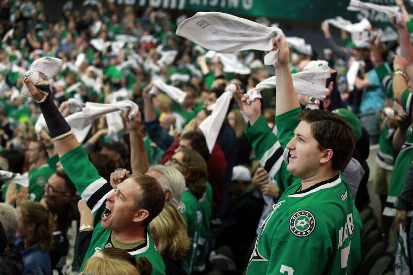 Dallas Stars fans celebrate Antoine Roussel's second period goal following a review during...