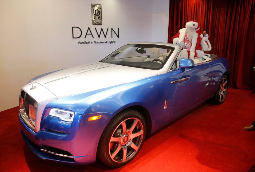 Santa Claus sits in one of the Yours & Mine Exclusive Rolls-Royce Dawn Drophead CoupÅ½s that...