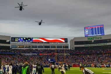 A pair of military helicopters fly over Highmark Stadium before the first half of an NFL...