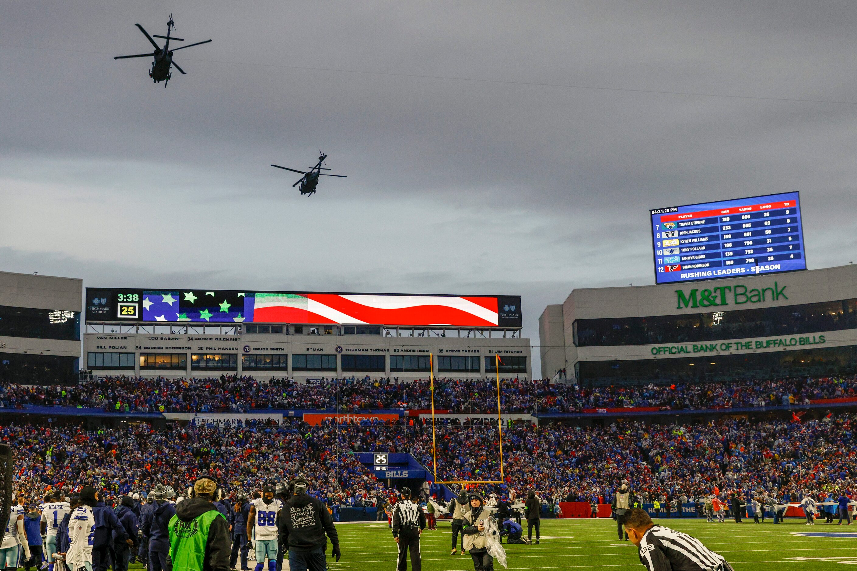 A pair of military helicopters fly over Highmark Stadium before the first half of an NFL...