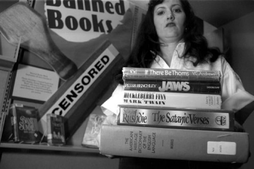  Melissa King Odle held a stack of books as part of  a the "Banned Books" display in the...