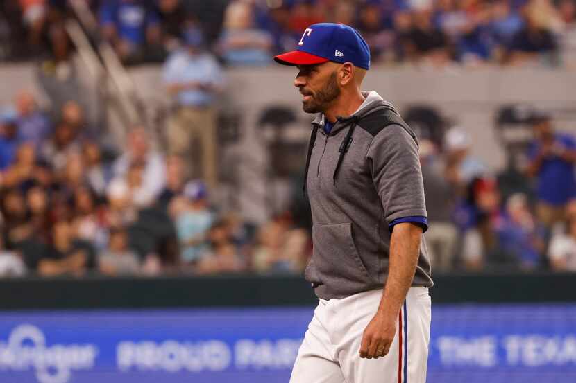 Texas Rangers manager Chris Woodward (8) walks to the dugout during the eighth inning...