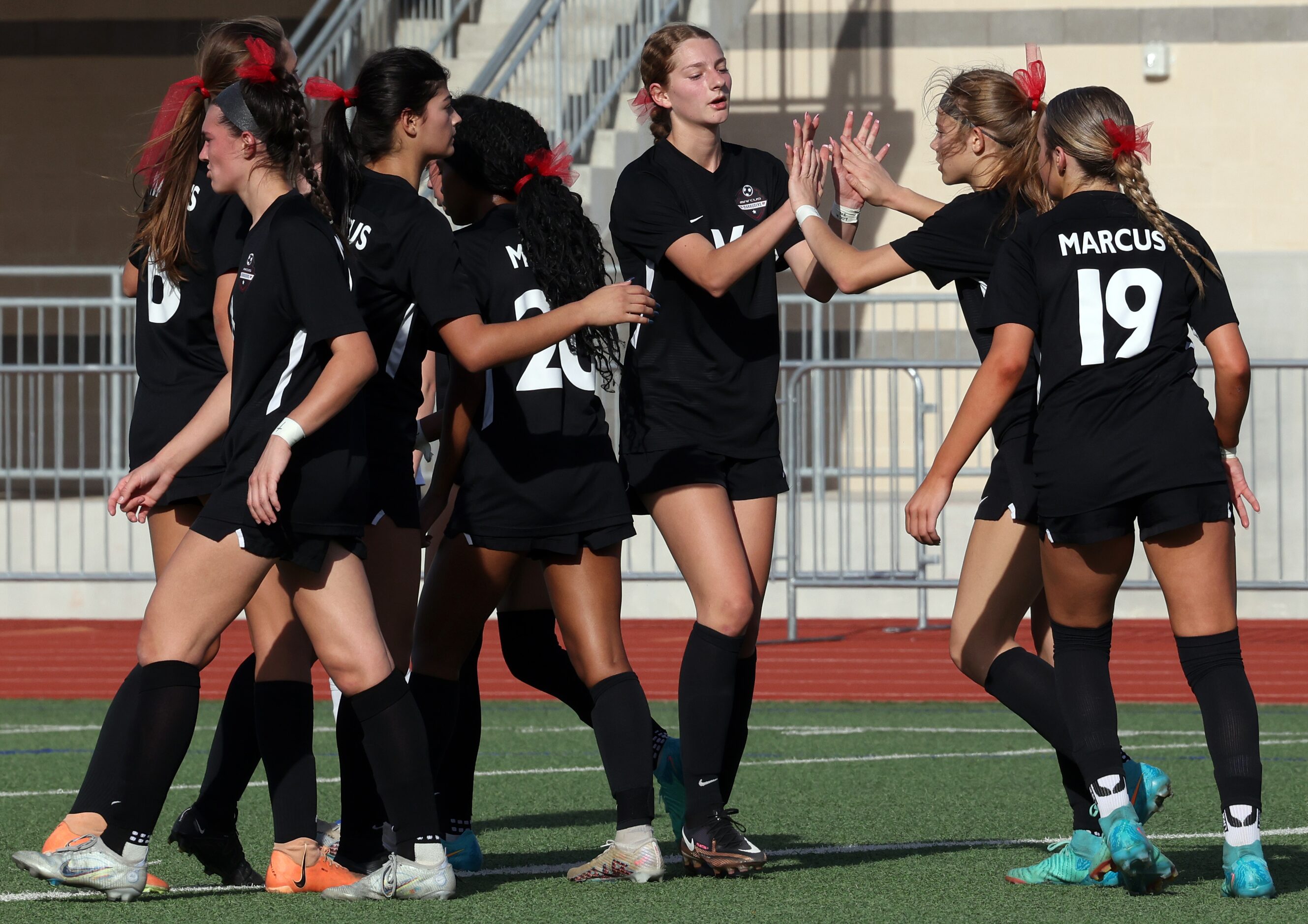 Flowers Mound Marcus forward Madi Patterson (17), second from right, receives...