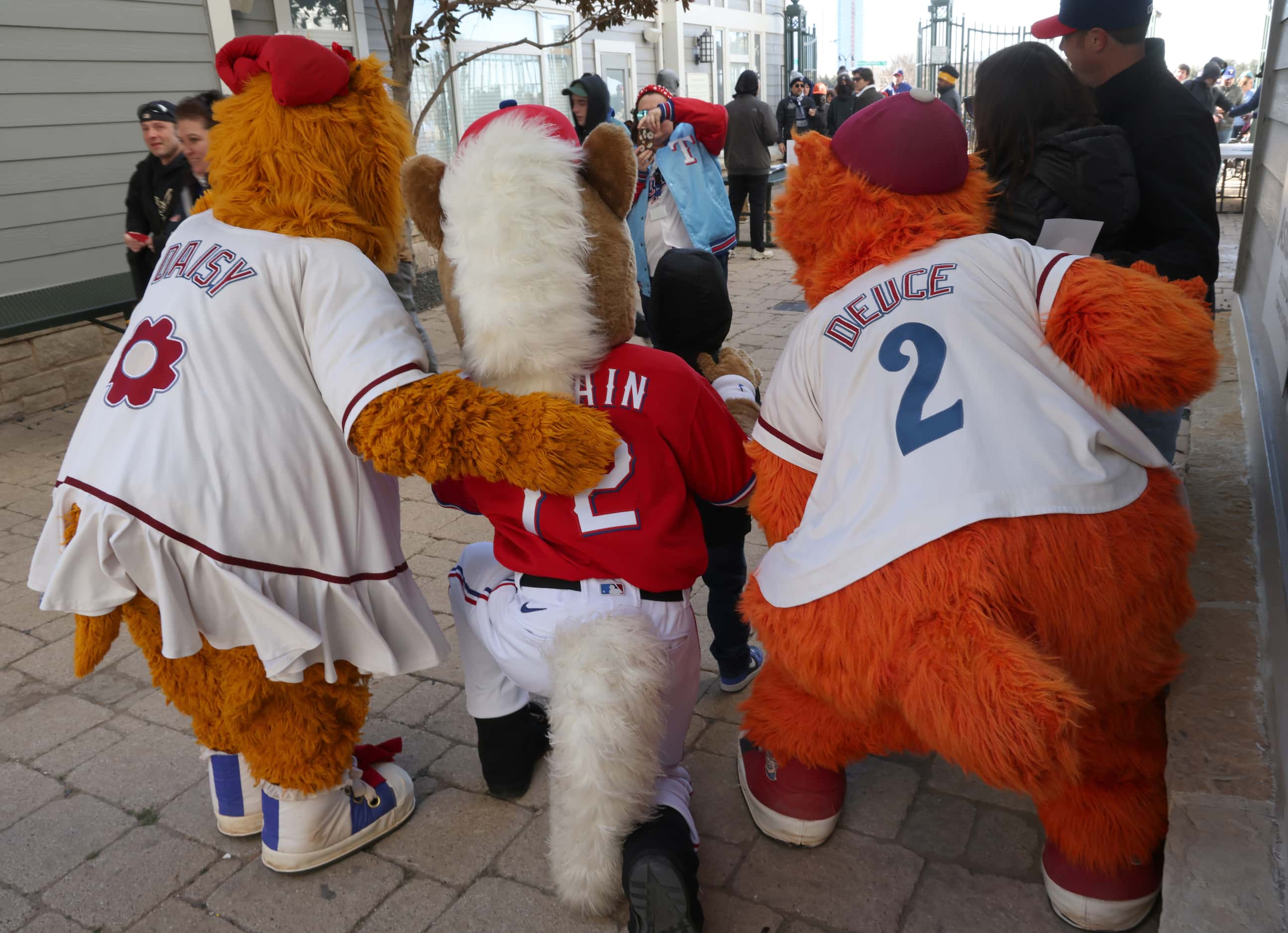 Team mascots representing the Texas Rangers and Frisco RoughRiders baseball teams pose with...