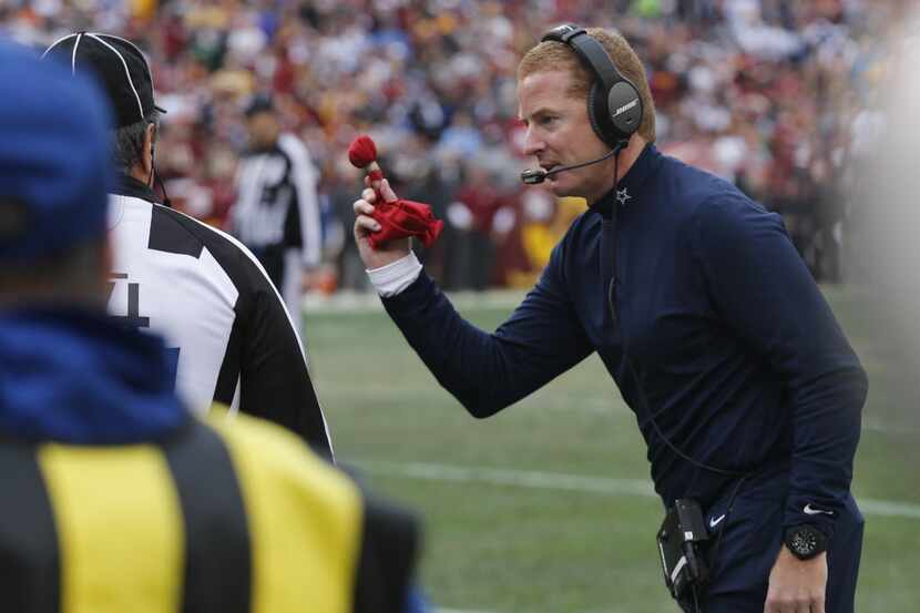 Dallas Cowboys head coach Jason Garrett throws the challenge flag on a touchdown by Dez...