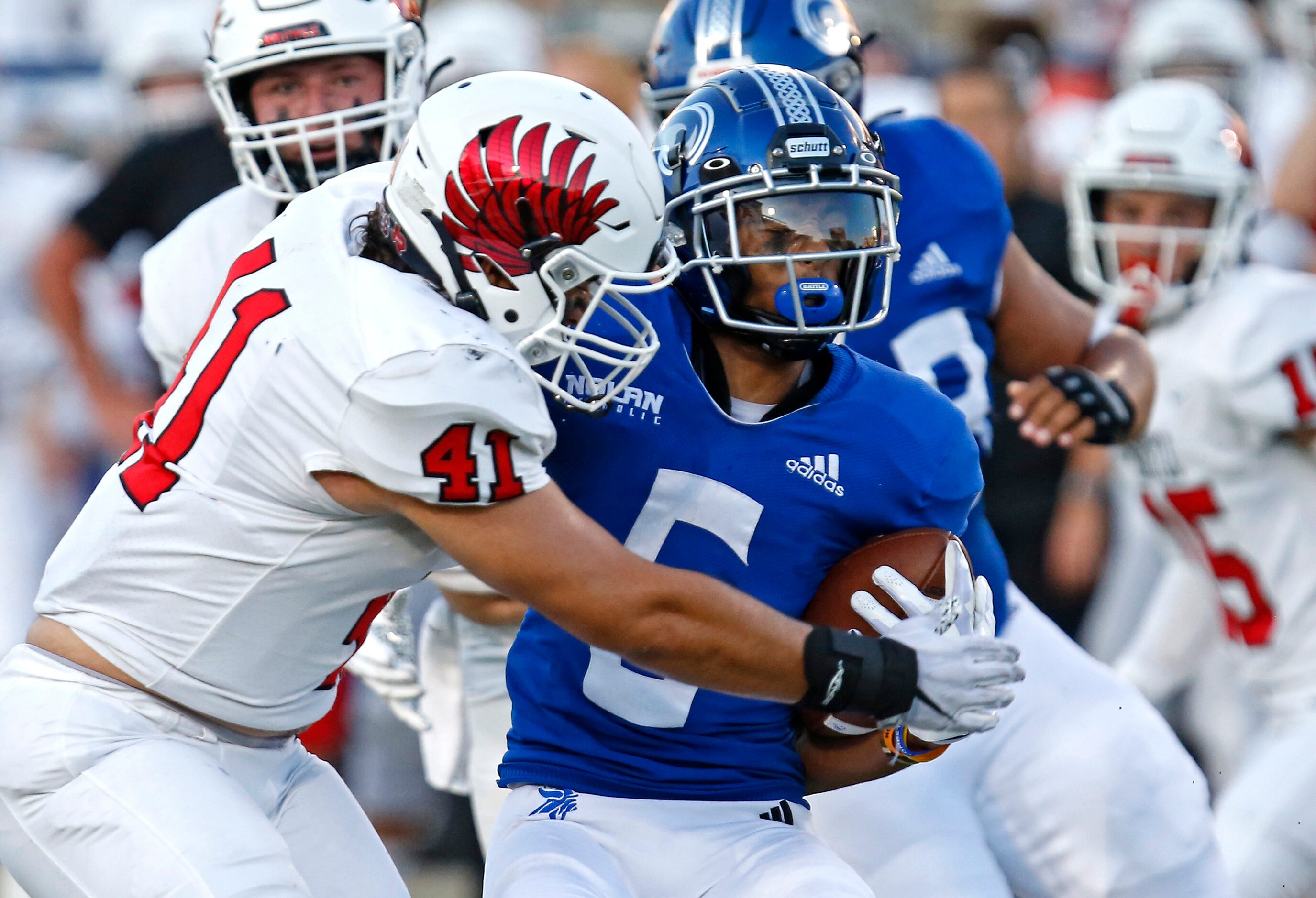 Argyle High School linebacker Ethan Gonzales (41) brings down Nolan Catholic High School...