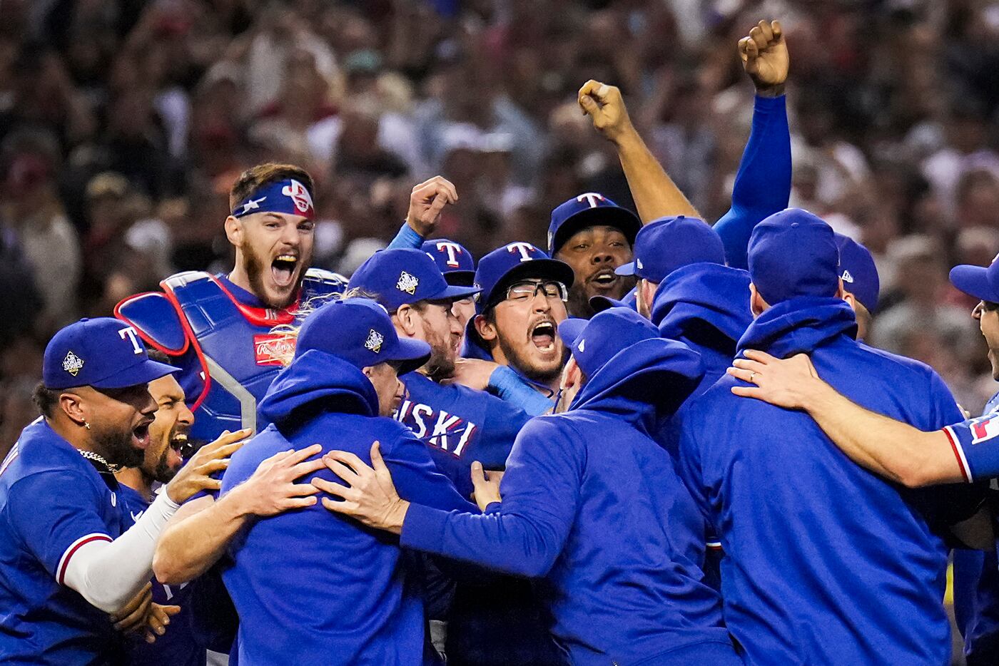 The Texas Rangers players celebrate the final out of a 5-0 victory over the Arizona...