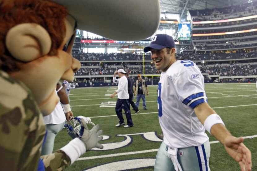 Dallas Cowboys quarterback Tony Romo (9) celebrates with Rowdy after a game between the...