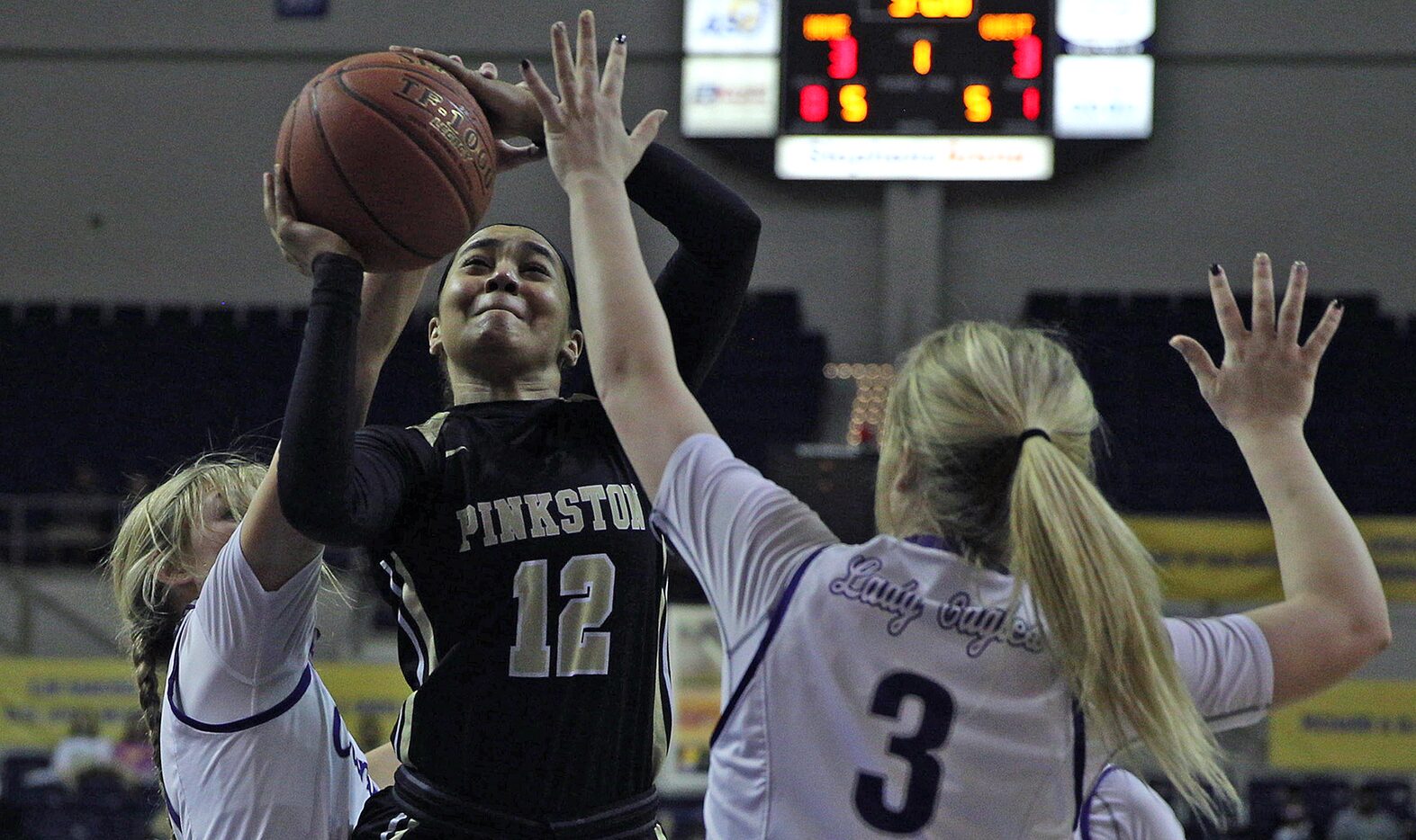 Tamia Flores (12), left, puts up a shot for Pinkston during the Texas UIL Girls 4A state...