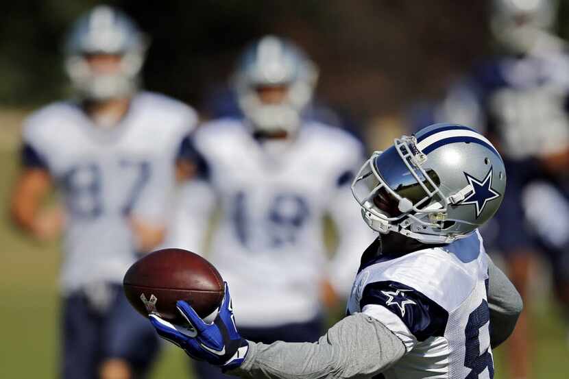 Dallas Cowboys wide receiver Dez Bryant reaches out to catch a pass during practice...