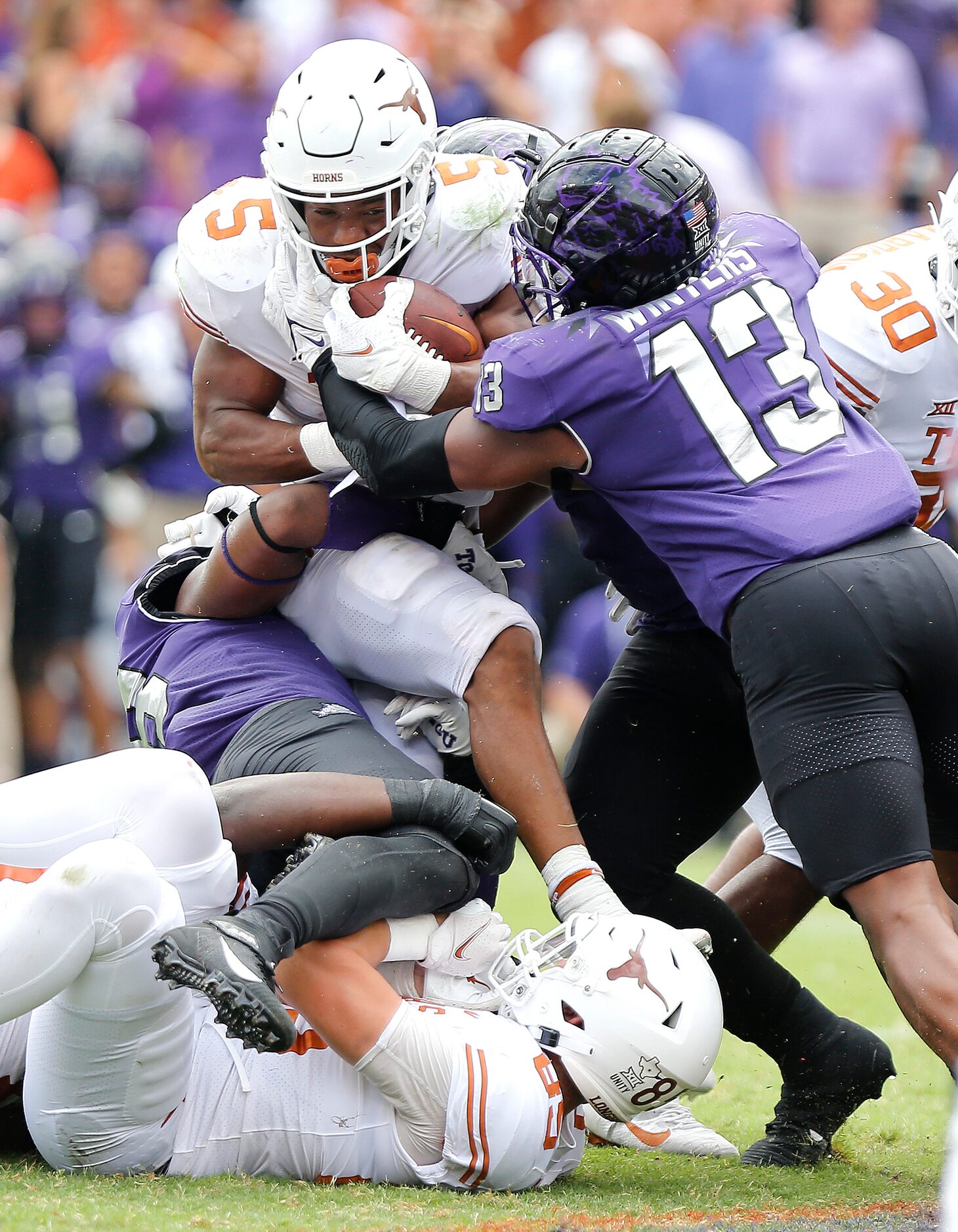 TCU Horned Frogs linebacker Dee Winters (13) helps team mates to stop Texas Longhorns...