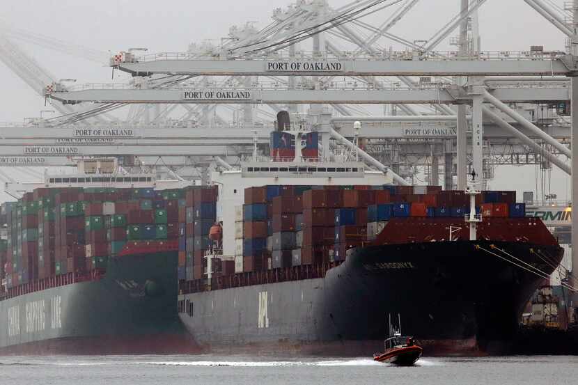 FILE - In this Wednesday, Oct. 23, 2013, file photo, container ships wait to be off loaded...