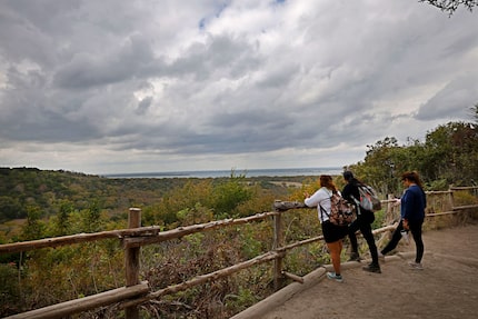 Hikers on Cattail Pond Trail stop at an overlook on Tuesday, Oct. 29, 2024, at Cedar Ridge...