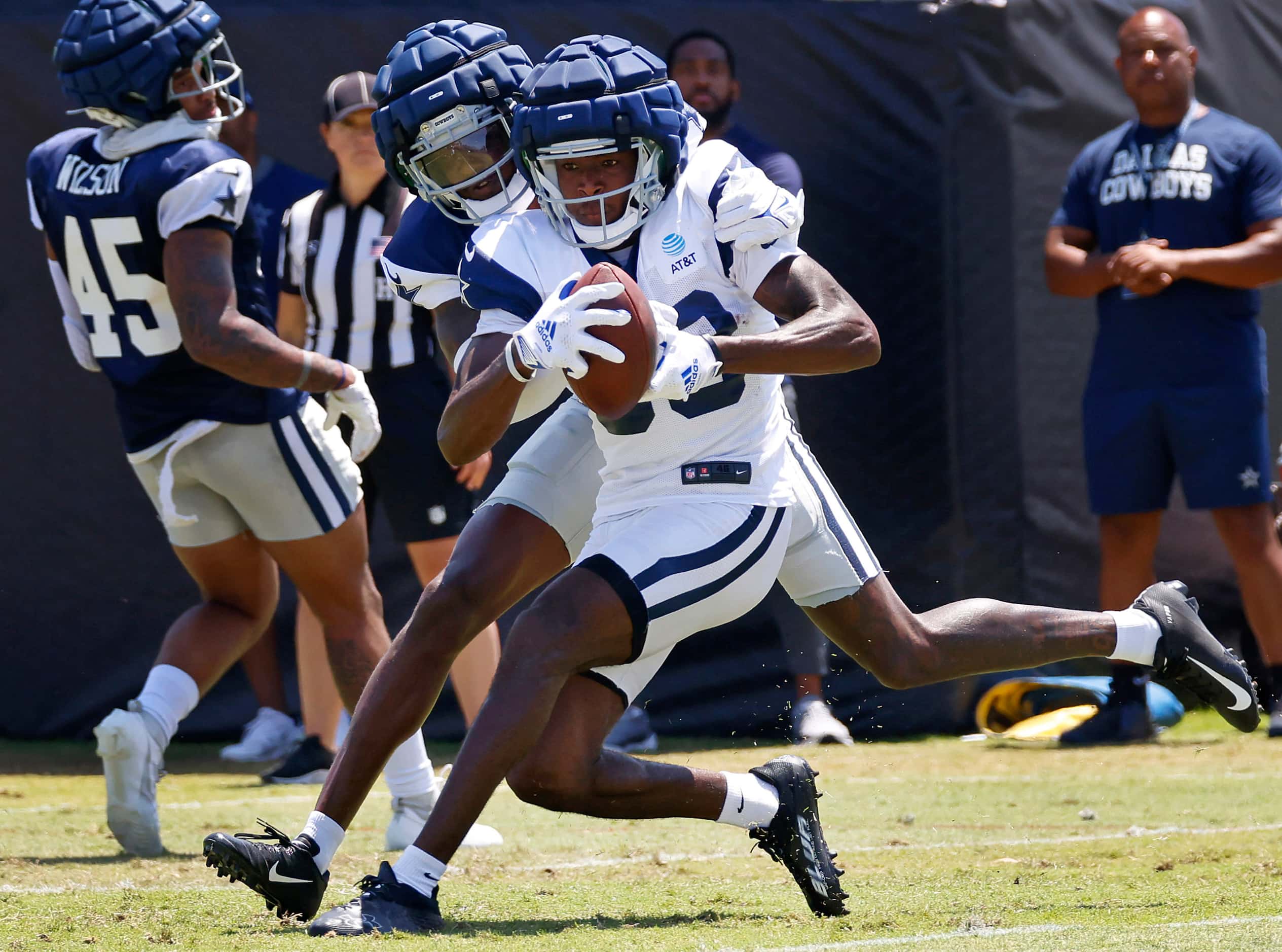 Dallas Cowboys wide receiver Jalen Brooks (83) catches a pass as he’s hit from behind by...