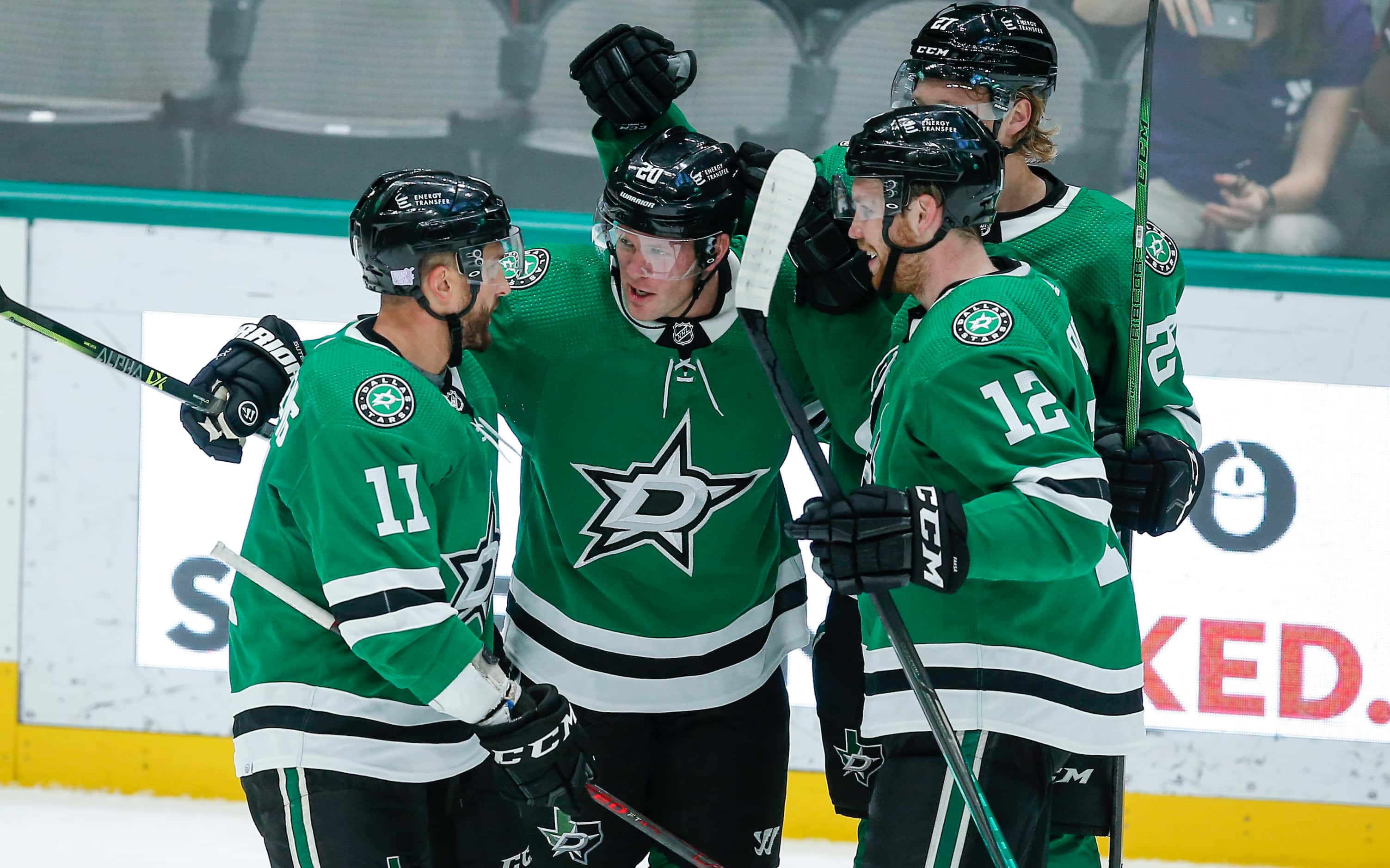 Dallas Stars defenseman Ryan Suter, second from left, is congratulated by teammates after...