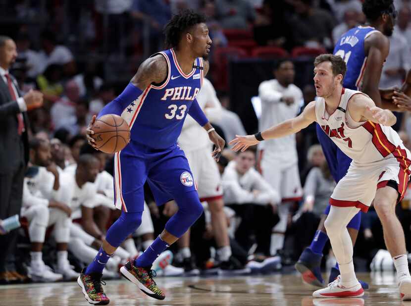 Miami Heat's Goran Dragic (7) defends Philadelphia 76ers' Robert Covington (33) during the...