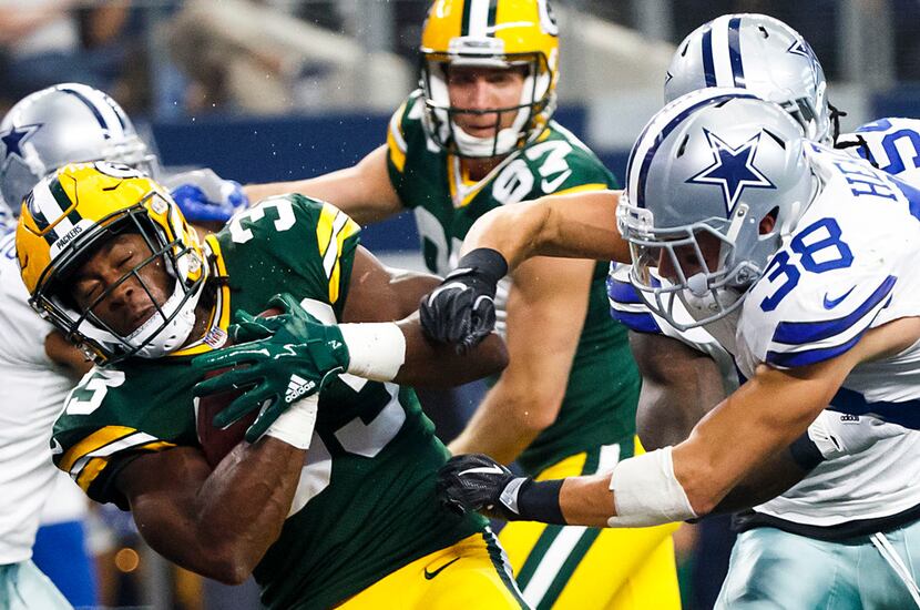 Green Bay Packers running back Aaron Jones (33) scores on a 7-yard touchdown run past Dallas...