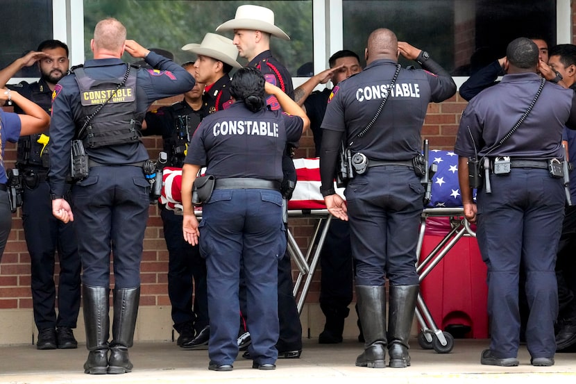 Law enforcement salute slain Harris County Precinct 4 Deputy Maher Husseini as he is...