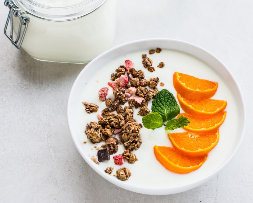 Homemade yogurt can be made in a variety of ways and then be topped with granola and fruit.