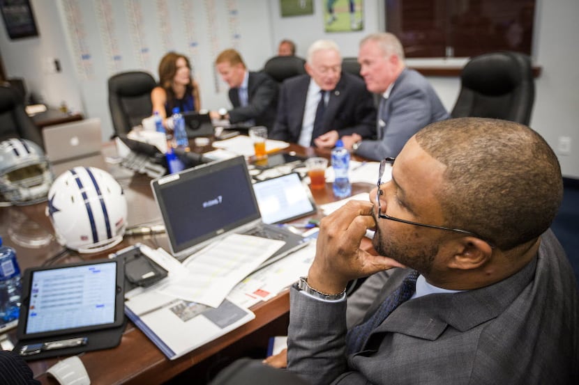 Dallas Cowboys assistant director of player personnel Will McClay watches early picks in the...