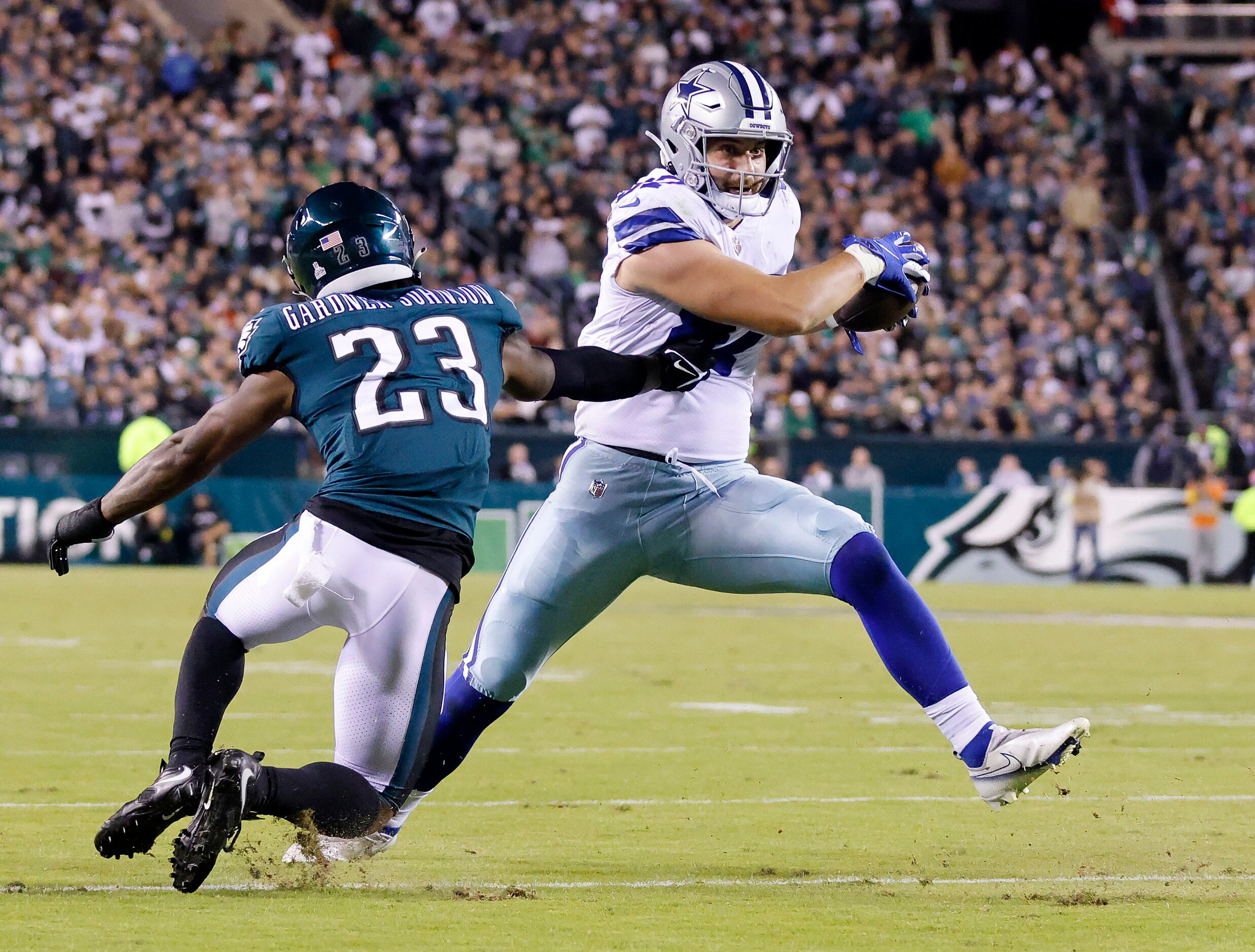 Dallas Cowboys tight end Jake Ferguson (87) cuts back against Philadelphia Eagles safety...