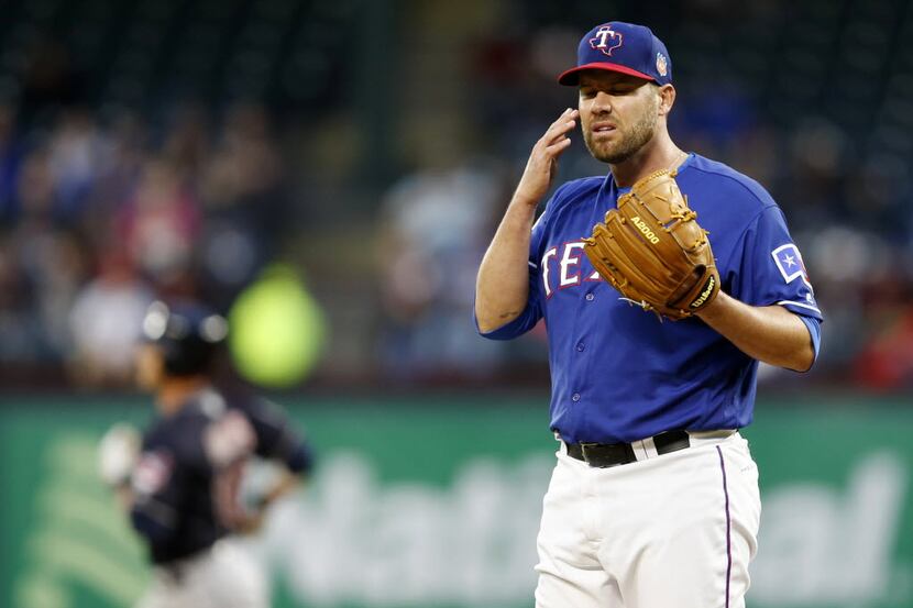 Texas Rangers starting pitcher Colby Lewis (48) reacts as Cleveland Indians catcher Yan...