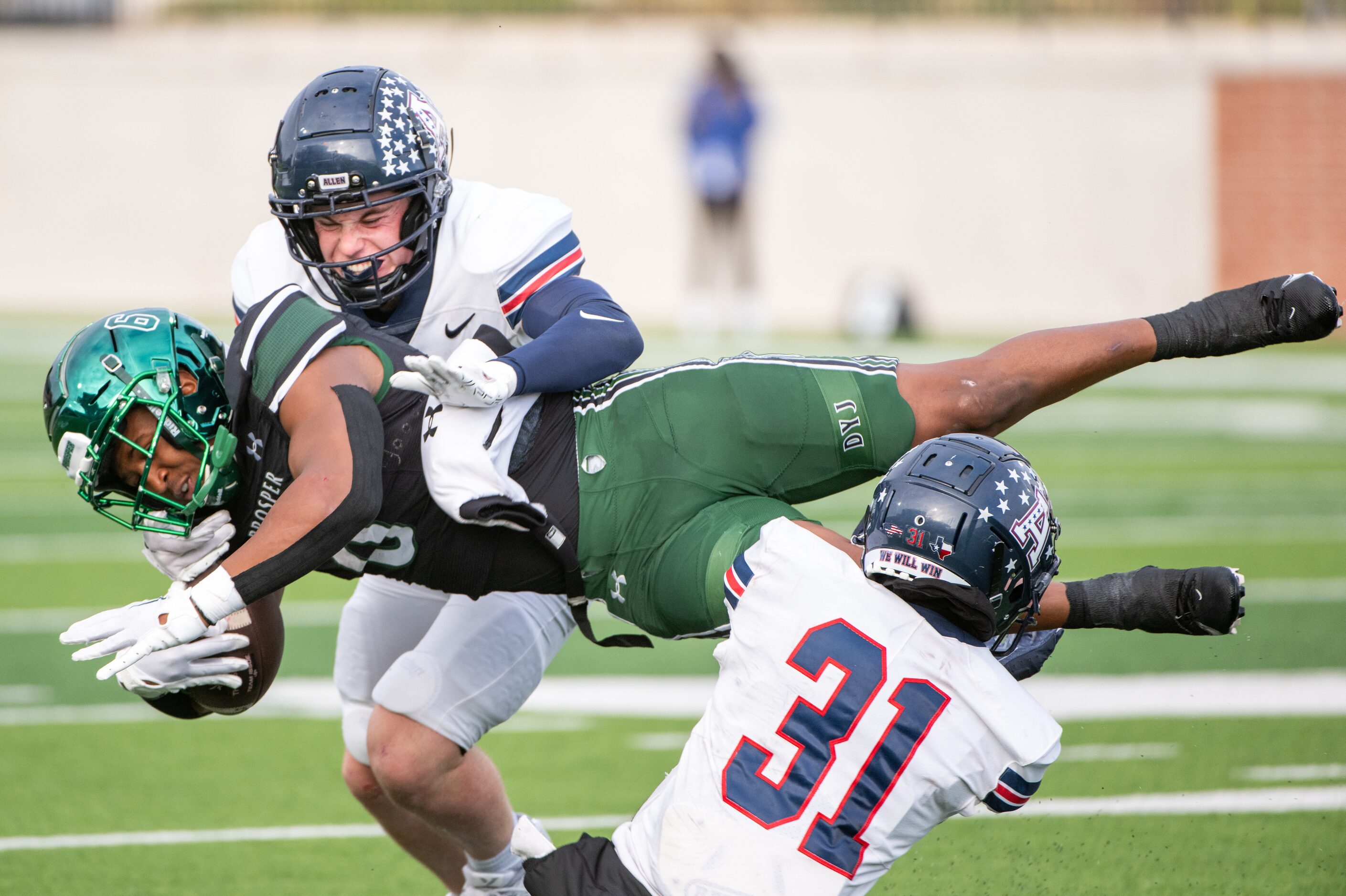 Allen’s linebacker Mitchell Neu (24) and Allen’s Camden Clark (31) tackle Prosper's Josh...