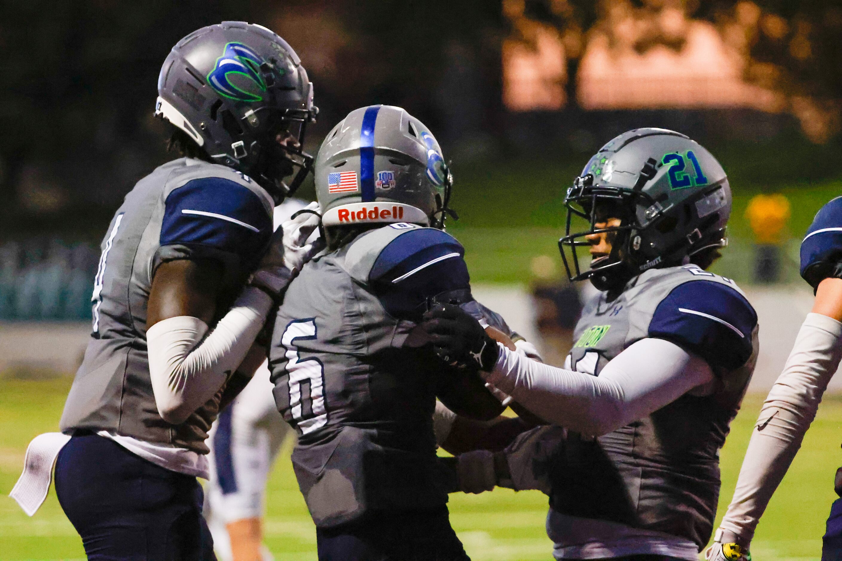 V.R. Eaton High School players celebrate cornerback Darius Nash (6) on intercepting a catch...