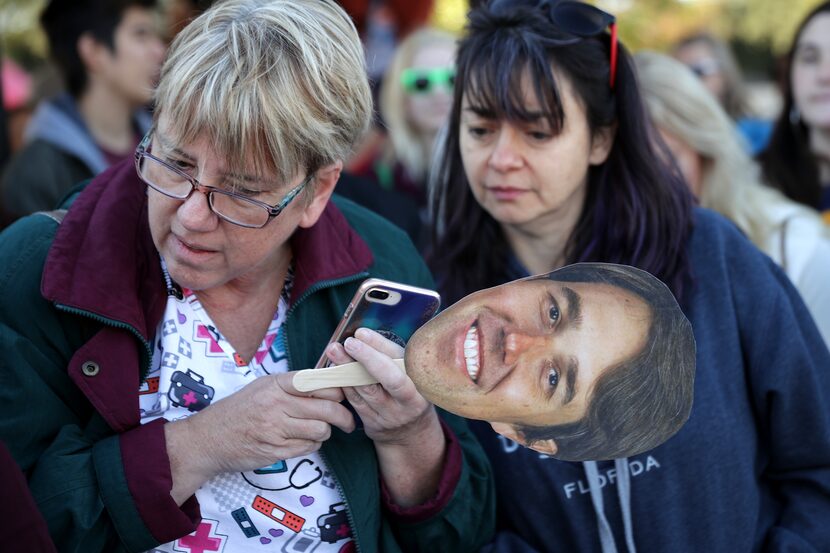 Beto O'Rourke supporters follow a live video live feed to keep track of his scheduled...