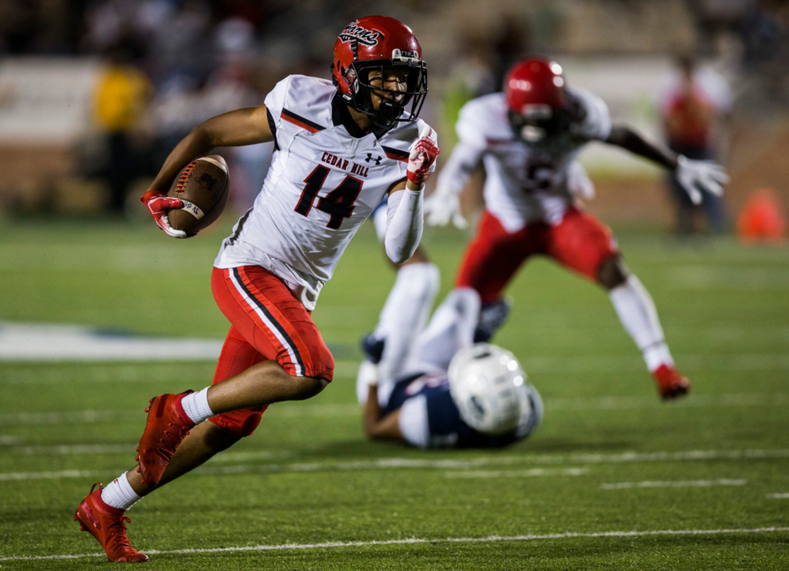 Cedar Hill wide receiver Anthony Thomas (14) runs the ball during the fourth quarter of a...