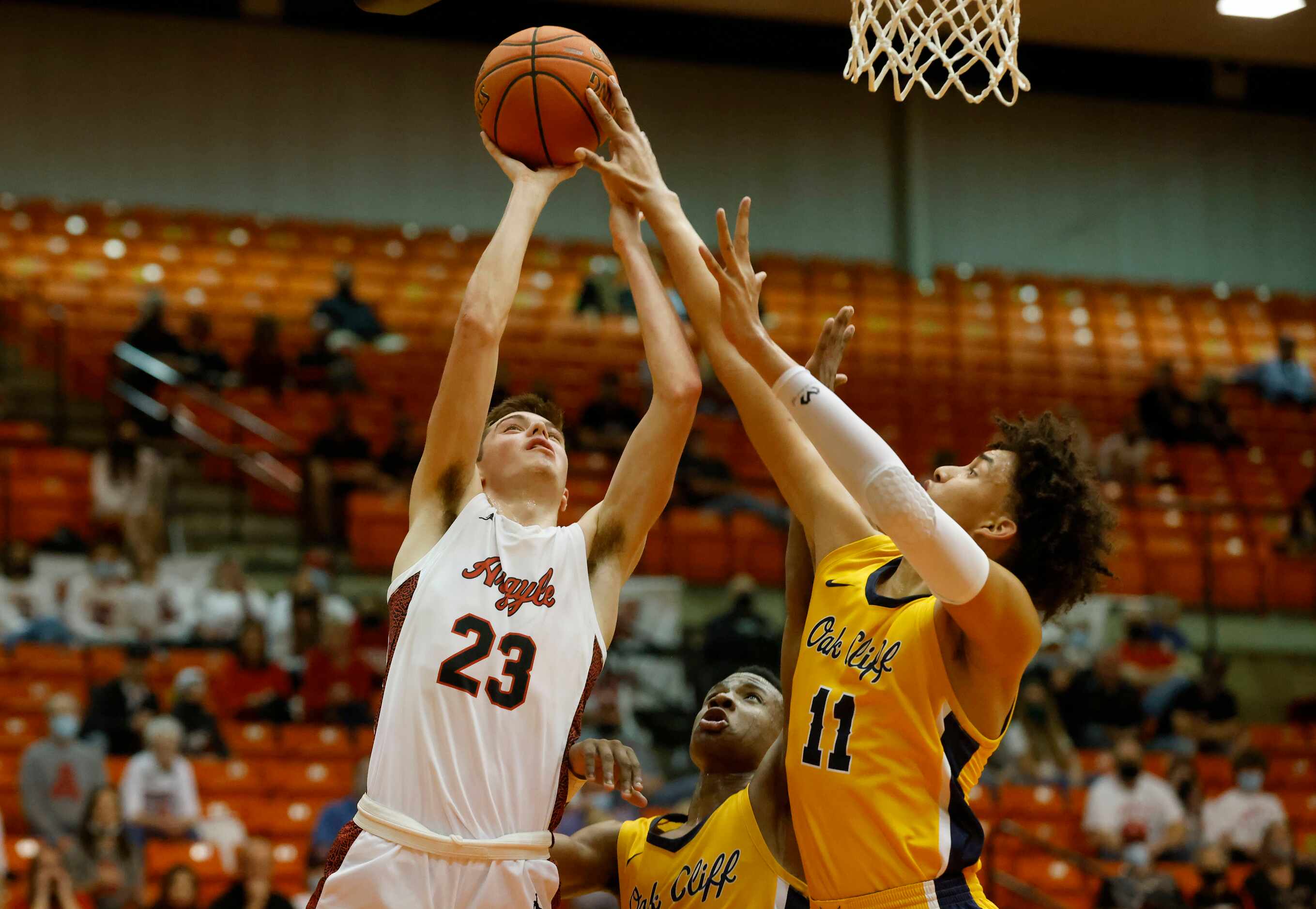 Argyles Eli Valentino (23) has a shot blocked by Faith Family’s Doryan Onwuchekwa (11) as TJ...