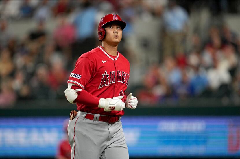 Los Angeles Angels' Shohei Ohtani jogs to the dugout after popping out to third in the...