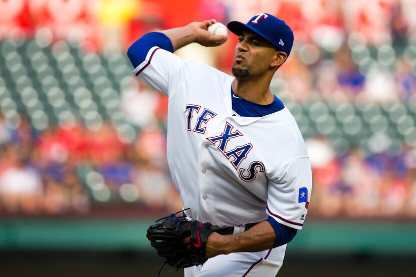 Texas Rangers starting pitcher Tyson Ross delivers a pitch during the first inning against...