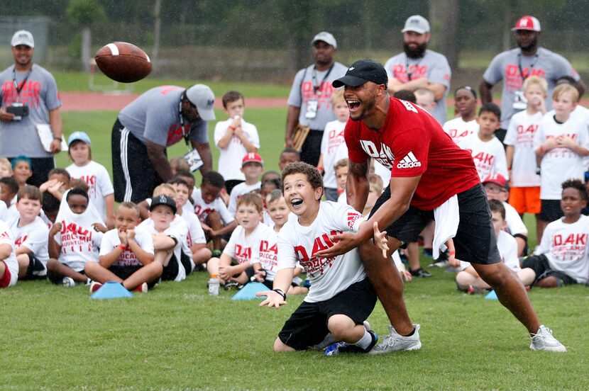 Dallas Cowboys quarterback Dak Prescott defends Sammy Mercer, 12 of Shreveport during a...