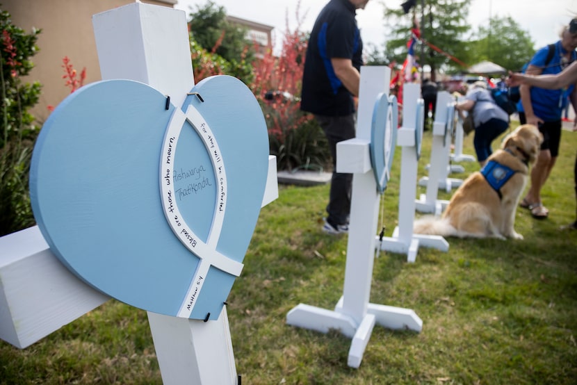 A cross for Aishwarya Thatikonda at the memorial outside the mall honoring the victims of a...