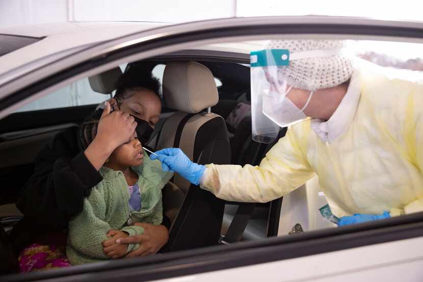 Tamera Stephens holds daughter Victoria Stephens, 2, from Waxahachie as Krystal Stroub with...