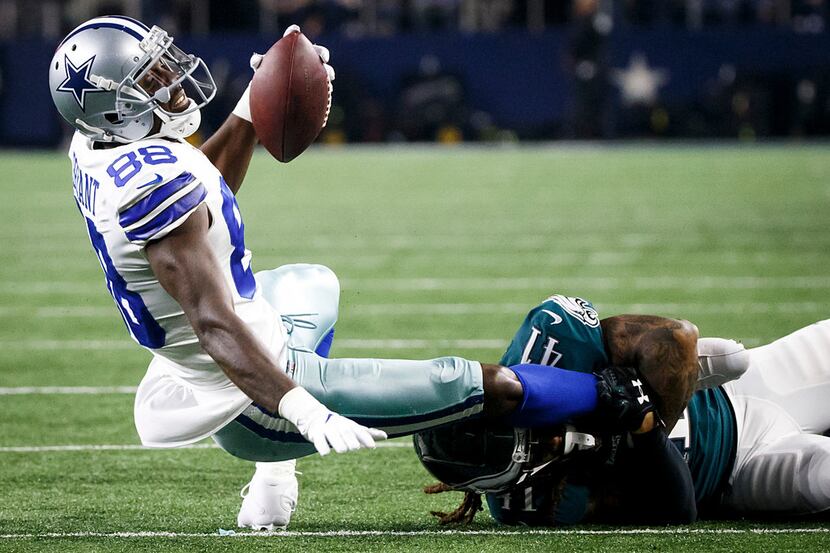 Dallas Cowboys wide receiver Dez Bryant (88) is brought down by Philadelphia Eagles...