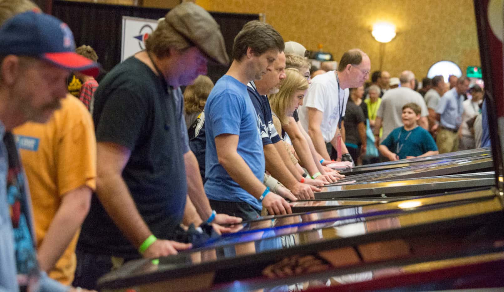 Pinball enthusiast of all ages take turns at the hundreds of games at the Texas Pinball...