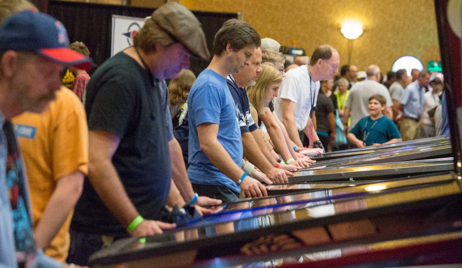 Pinball enthusiast of all ages take turns at the hundreds of games at the Texas Pinball...