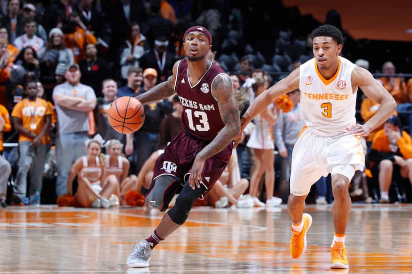 KNOXVILLE, TN - JANUARY 13: Duane Wilson #13 of the Texas A&M Aggies dribbles up court...