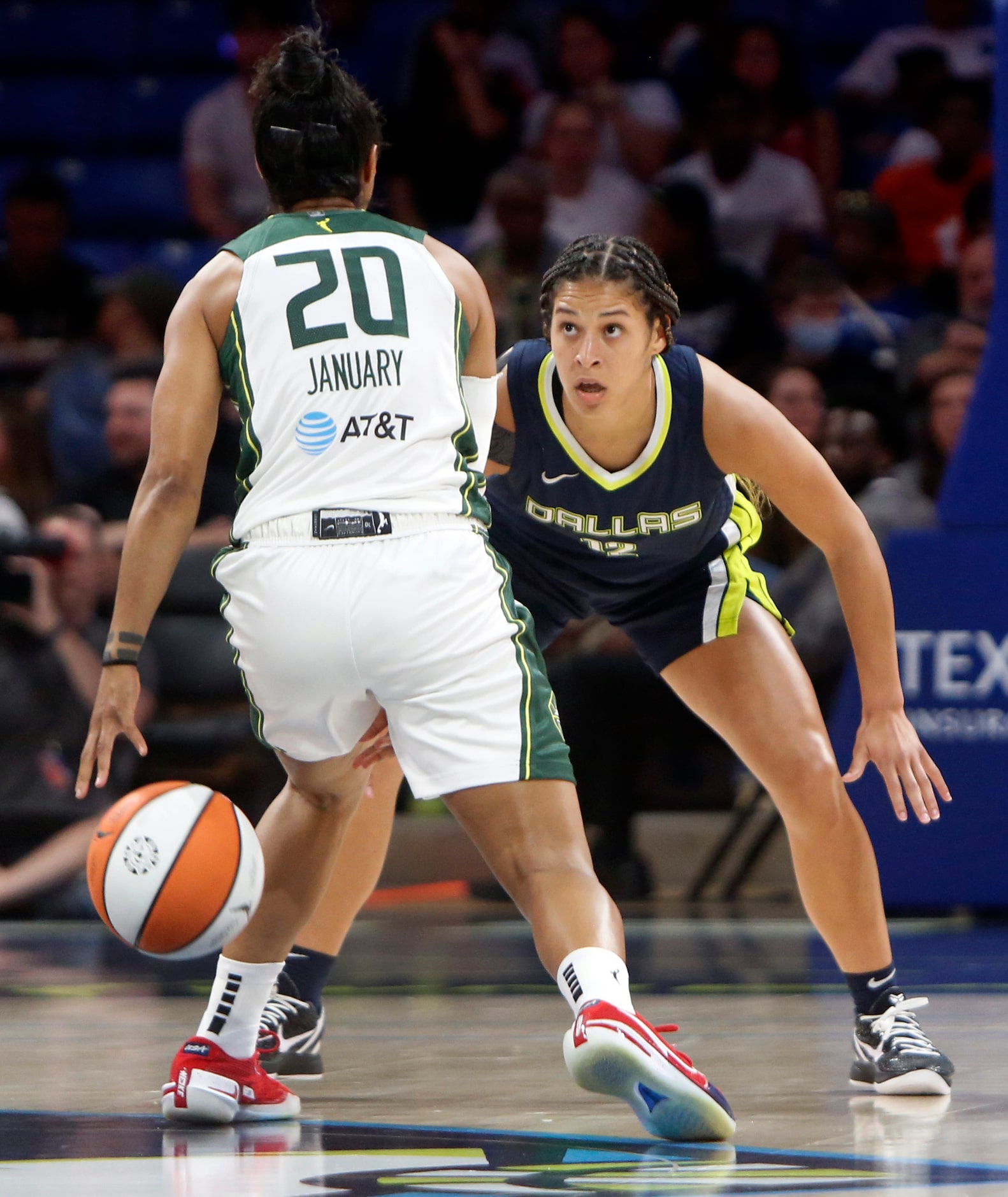 Dallas Wings guard Veronica Burton (12) focuses defensively on Seattle Storm guard Briann...