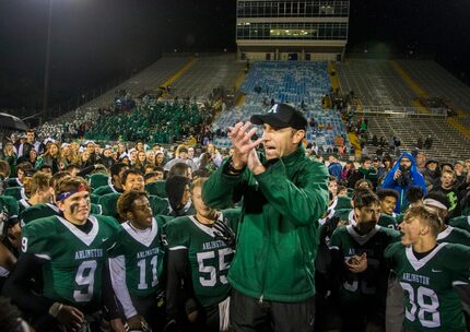 Head coach Scott Peach thanks the coaching staff after winning the high school football game...