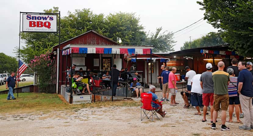 People wait in line for Snow's BBQ to open at 8 a.m.