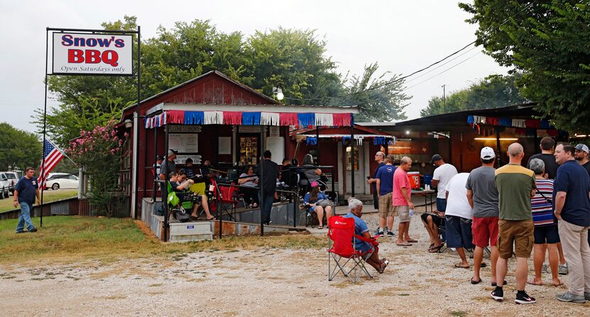 People wait in line for Snow's BBQ to open at 8 a.m.