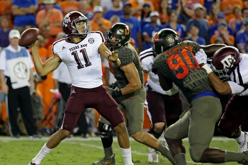 Texas A&M quarterback Kellen Mond (11) throws a pass as he is pressured by Florida defensive...