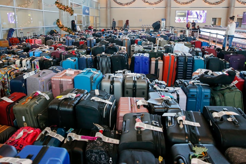 Hundreds of unclaimed bags sat outside the Southwest Airlines baggage service office at...