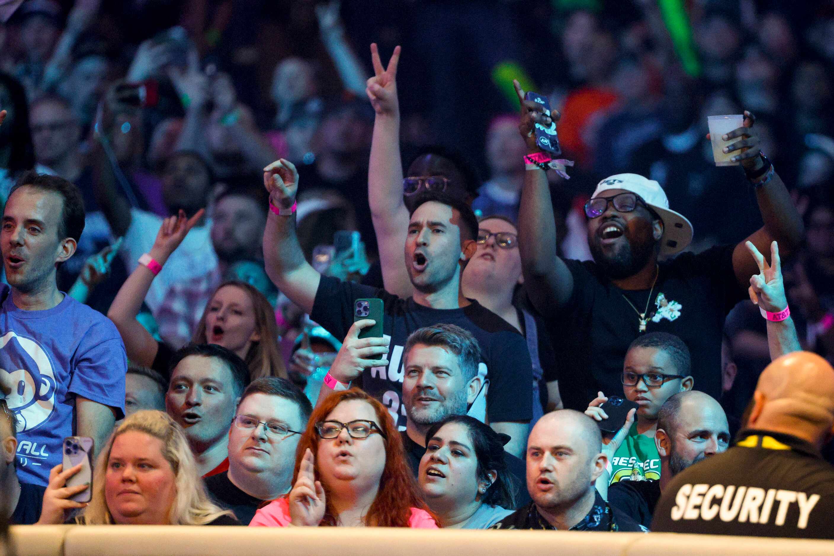 Wrestling fans cheer during a match between The Miz & Logan Paul vs. The Mysterios during...