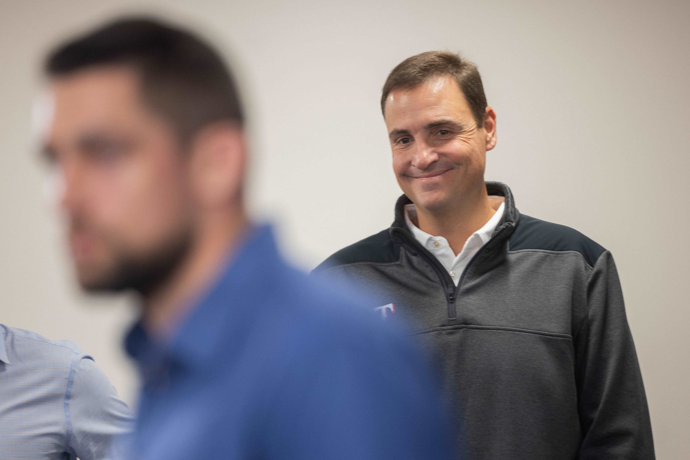 Texas Rangers GM Chris Young smiles as Rangers starting pitcher Nathan Eovaldi answers...