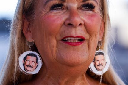 Plano resident Barbara Tomasino, wearing earrings with Guillermo Rodriguez's face on them,...
